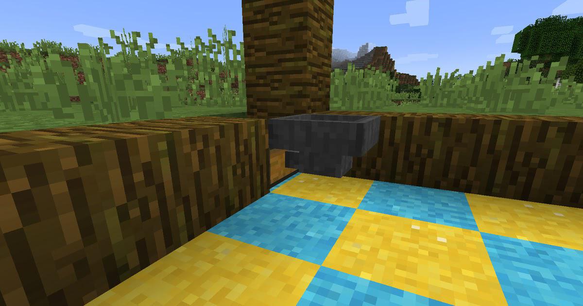 マインクラフトで畑の枠組みを原木で組んでいる途中の様子