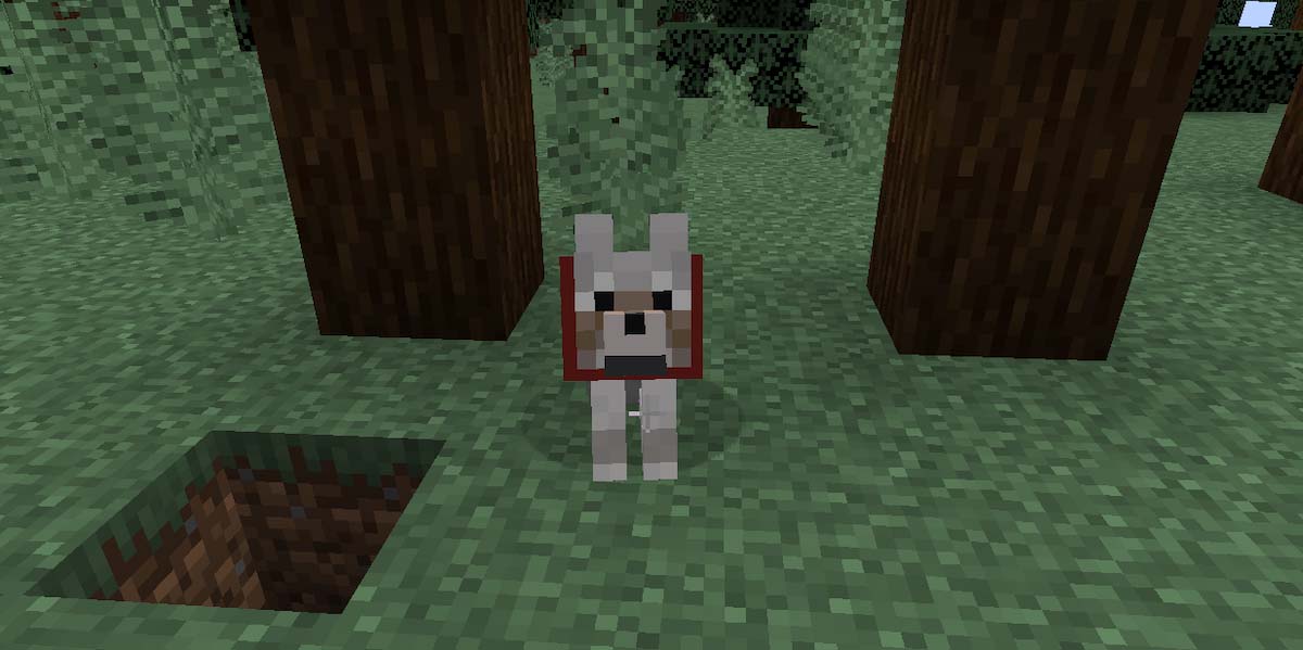 オオカミに骨を使って手懐ける様子のマインクラフトゲーム内画面
